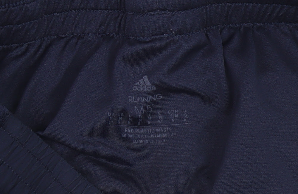Close-up detail of Adidas boys’ blue athletic running shorts m