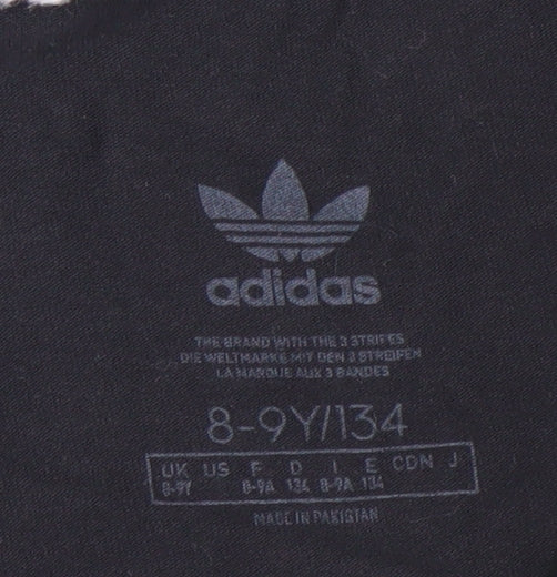 Close-up detail of Adidas girls’ black track pants 8-9 years