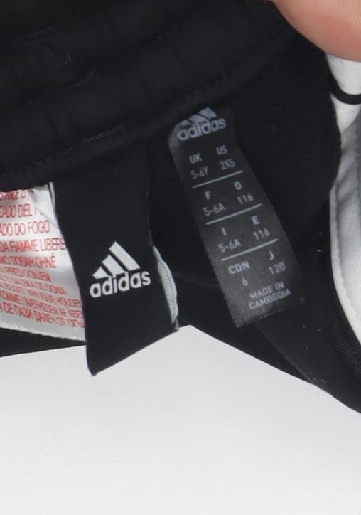Close-up detail of Adidas boys’ black track pants s - activewear, football