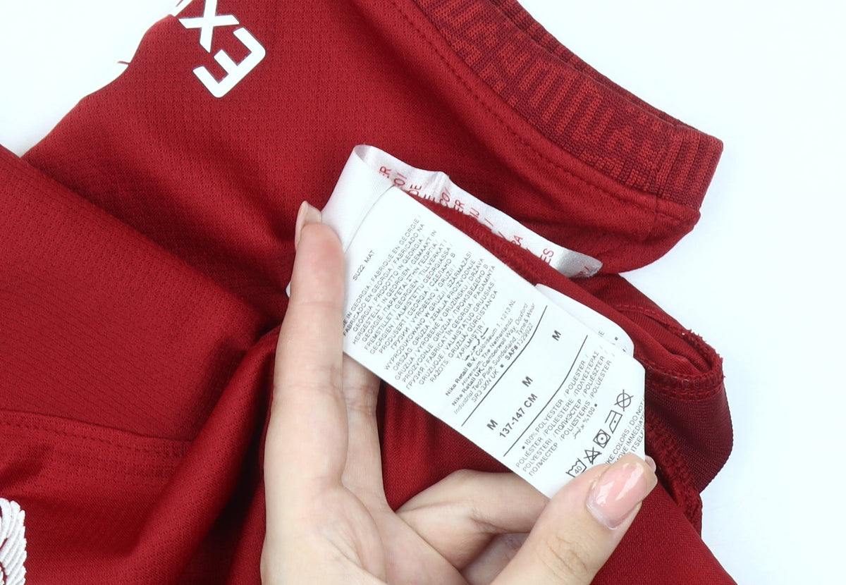 Brand and care label for Nike boys’ red liverpool jersey short sleeve football top 10-11