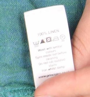 Brand and care label for Principles Women's Green Linen Trousers, size 12