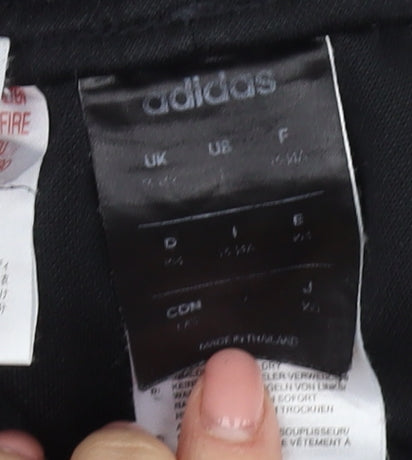 Brand and care label for Adidas boys’ black jogger trousers, size M, sportswear