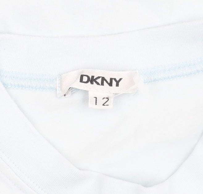 Brand and care label for DKNY girls’ blue t-shirt, size 12, years, short sleeve, logo