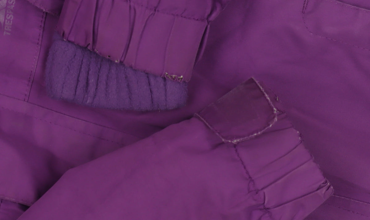 Brand and care label for Trespass girls’ purple rain coat jacket, size 5-6, years