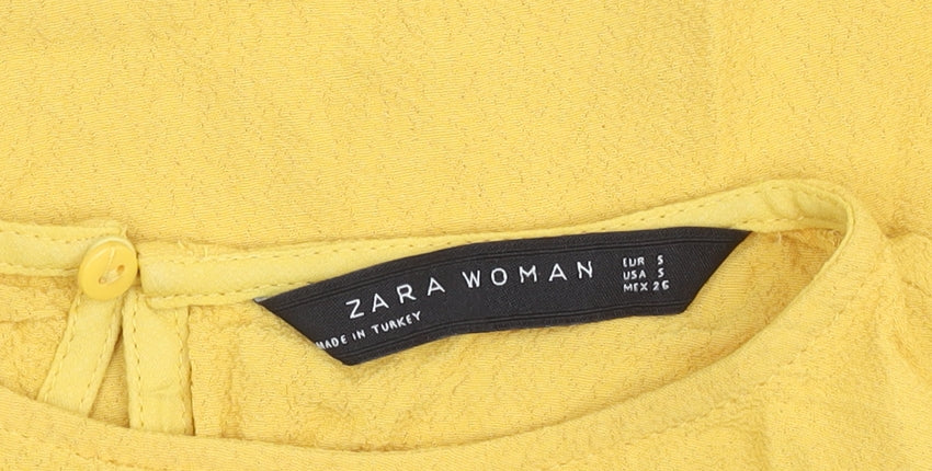 Close-up detail of Zara Woman Yellow Short Sleeve Top, size 8, Round Neck