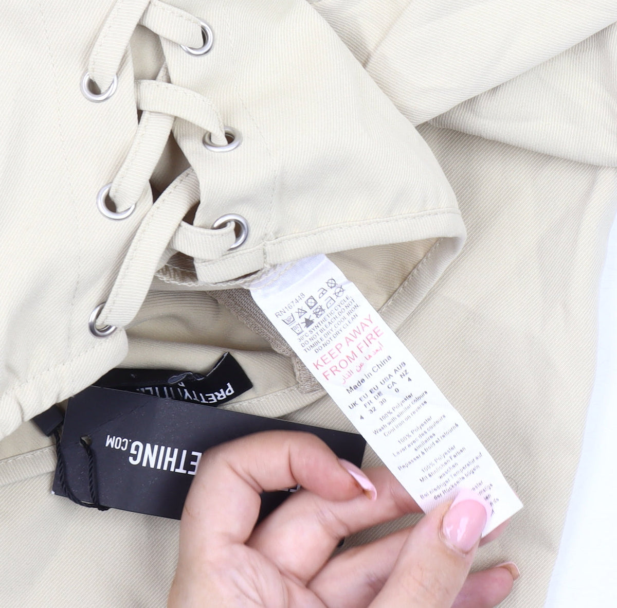 Brand and care label for PRETTYLITTLETHING Beige Strapless Jumpsuit UK 4 Petite