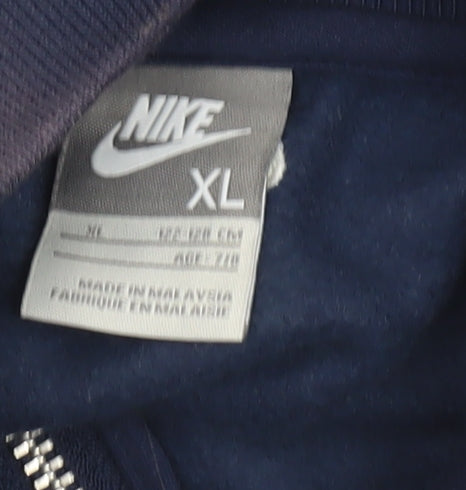 Brand and care label for Nike boys’ blue track jacket xl with logo