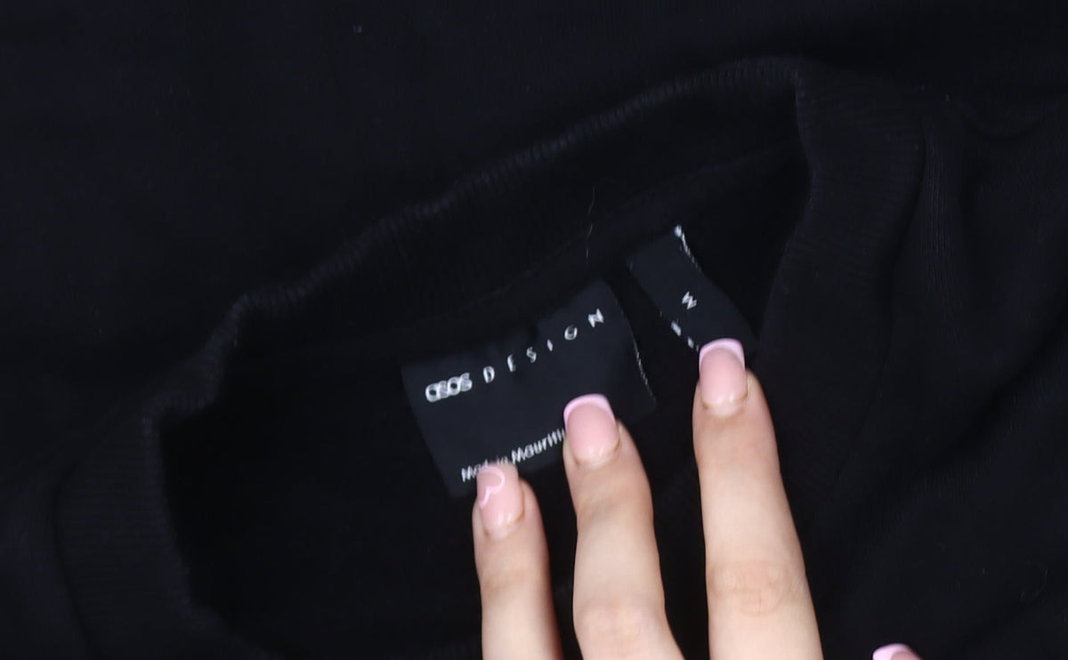 Close-up detail of ASOS DESIGN Men's Black M Embroidered Pullover Sweatshirt