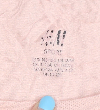 Brand and care label for H&M girls’ pink sleeveless t-shirt, size 10-11, years