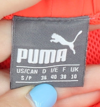 Brand and care label for Puma Women's Orange Athletic Shorts, size 10