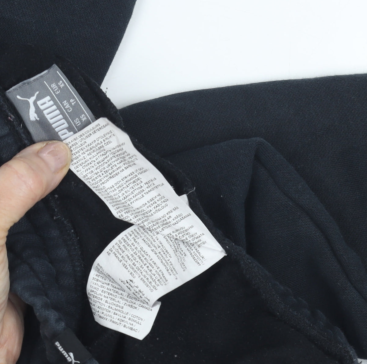Close-up detail of Puma boys’ black jogger trousers, size 9-10, years