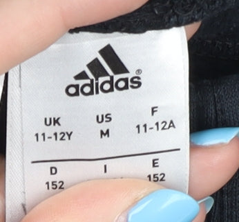 Brand and care label for Adidas boys’ black jogger trousers 11-12y sports activewear