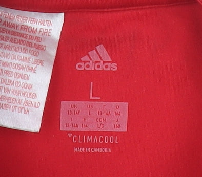 Brand and care label for Adidas boys’ red manchester united polo jersey l