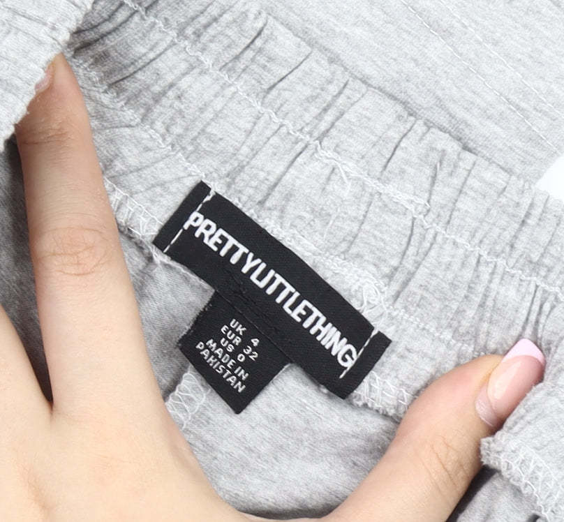 Brand and care label for PRETTYLITTLETHING Women’s Grey Track Pants, size UK 4