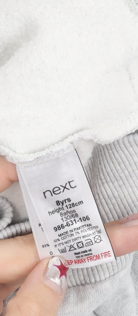 Brand and care label for Next girls’ grey full zip hoodie with ruffle detail age 8 years