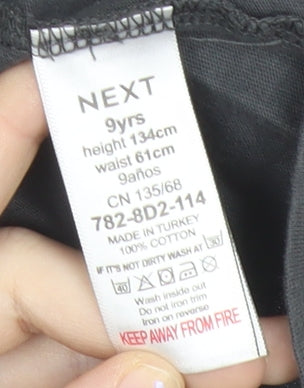 Brand and care label for Next girls’ black star studded cotton t-shirt age 9 crew neck casual
