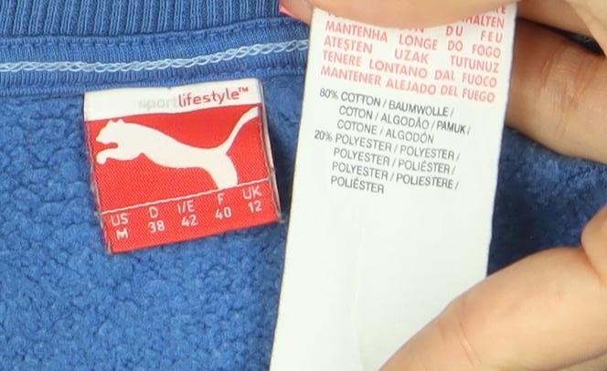 Brand and care label for Puma women’s blue cotton blend crew neck pullover sweatshirt, size UK 12