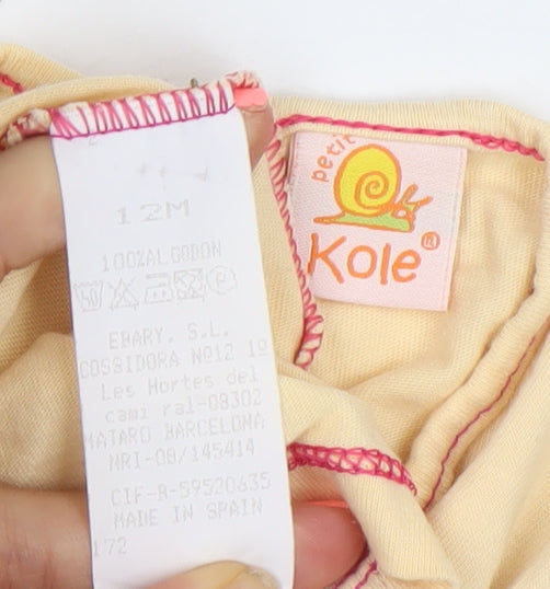 Brand and care label for Kole girls’ beige cotton short sleeve graphic t-shirt 12 months