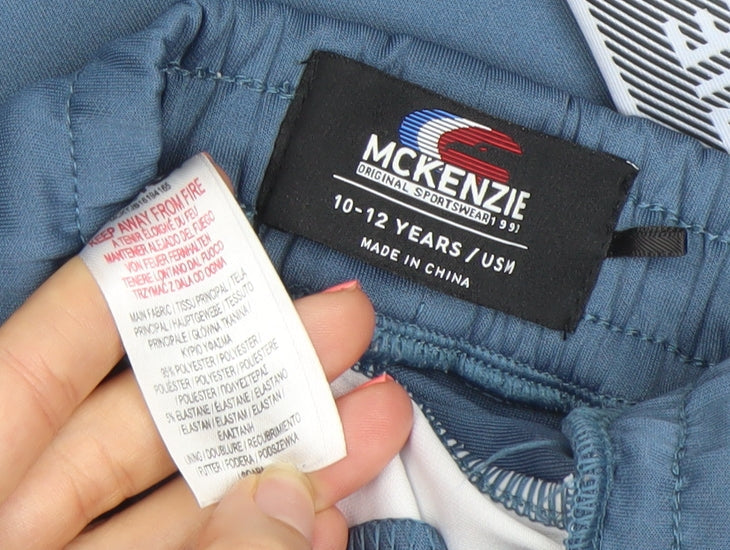 Brand and care label for McKenzie boys’ blue 10-12 years jogger trousers with side stripe