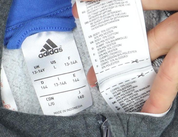 Brand and care label for Adidas boys’ dark grey full zip hoodie 13-14 years cotton blend logo
