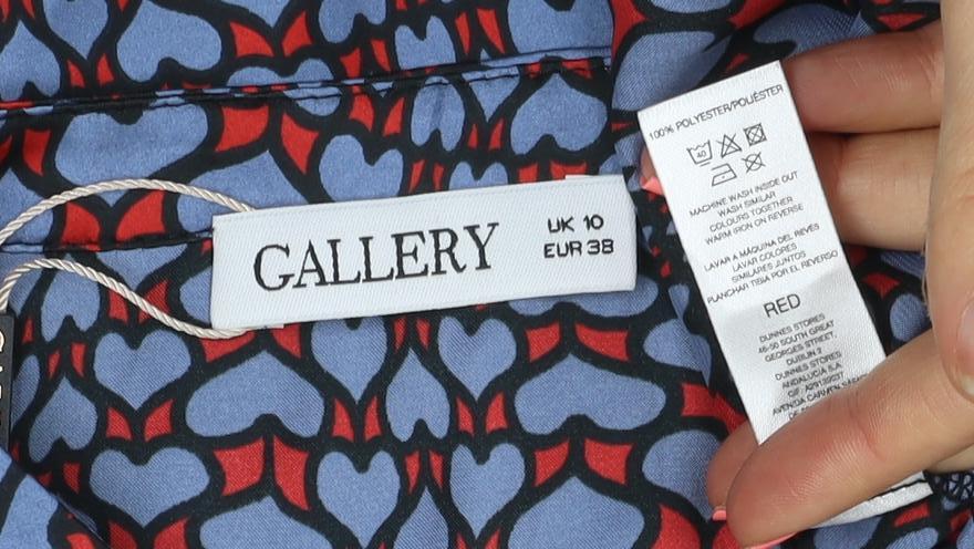 Brand and care label for Gallery women’s blue heart print long sleeve button blouse, size UK 10