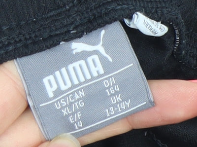 Brand and care label for Puma boys’ black 13-14 years track pants quick dry stretch tapered