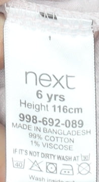 Brand and care label for Next girls’ beige long sleeve unicorn graphic t-shirt 6 years