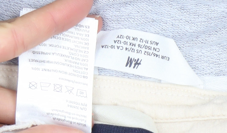 Brand and care label for H&M girls’ blue beige striped long sleeve polo top 10-12 years