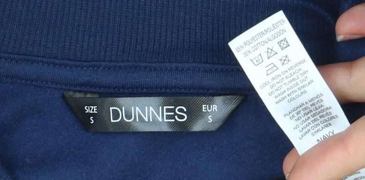 Brand and care label for Dunnes Women’s Navy Blue Munich Graphic Pullover Sweatshirt, size S