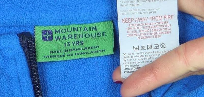 Brand and care label for Mountain Warehouse boys’ blue full zip fleece jacket 13 years