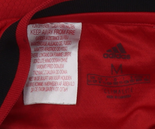 Brand and care label for Adidas boys’ red manchester united football jersey short sleeve, size M