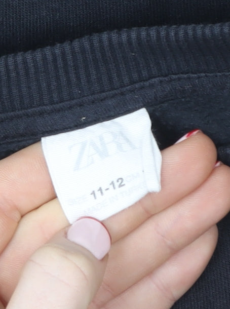 Brand and care label for Zara girls’ black ruffle embroidered pullover sweatshirt 11-12 years