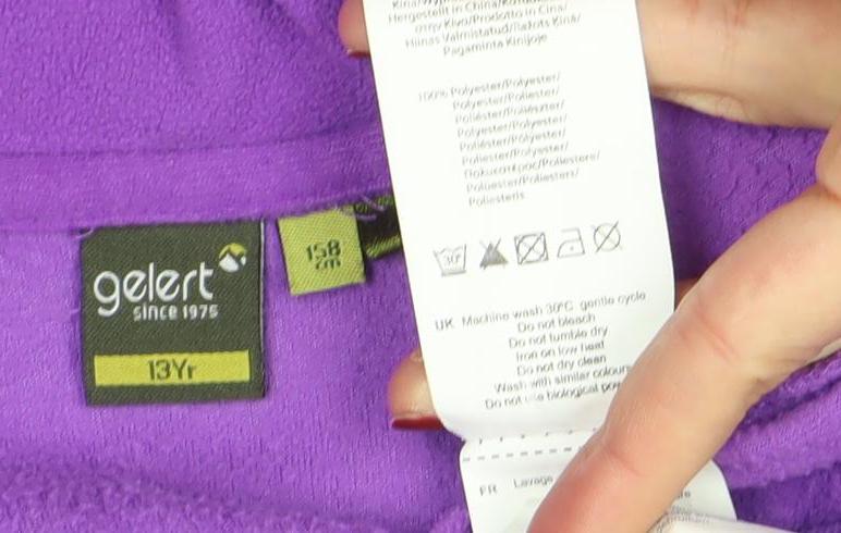 Brand and care label for Gelert girls’ purple fleece 1/4 zip sweatshirt 13-14 years outdoor layer