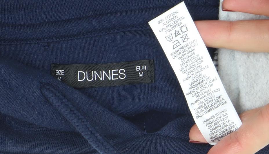 Brand and care label for Dunnes men’s blue colour block pullover hoodie, size M