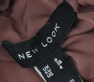 Brand and care label for New Look girls’ brown quilted puffer jacket, size 8, years