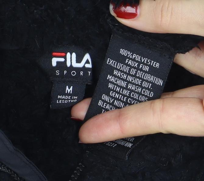 Brand and care label for Fila women’s black fleece full zip jacket, size M