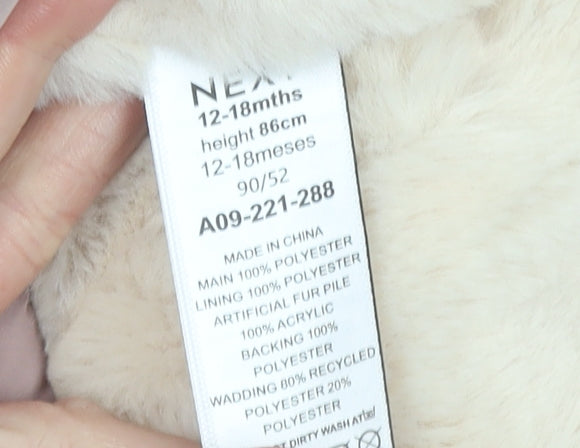Brand and care label for Next girls’ pink faux fur hooded winter parka coat 12-18 months
