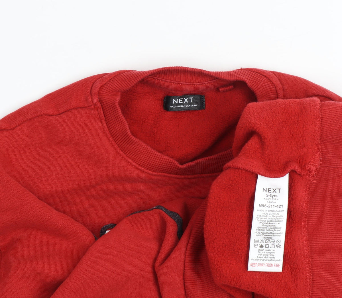 Brand and care label for Next boys’ red reindeer christmas sweatshirt 5-6 years pullover fleece