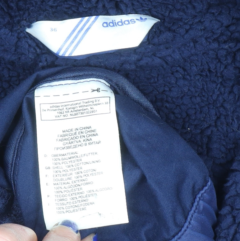 Brand and care label for Adidas women’s blue hooded parka jacket, size UK 36, lined cotton blend