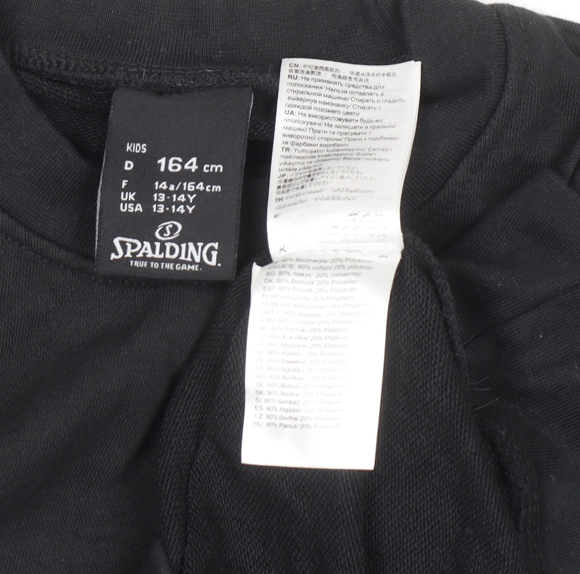 Brand and care label for Spalding boys’ black 13-14 years pullover sweatshirt crew neck long sleeve