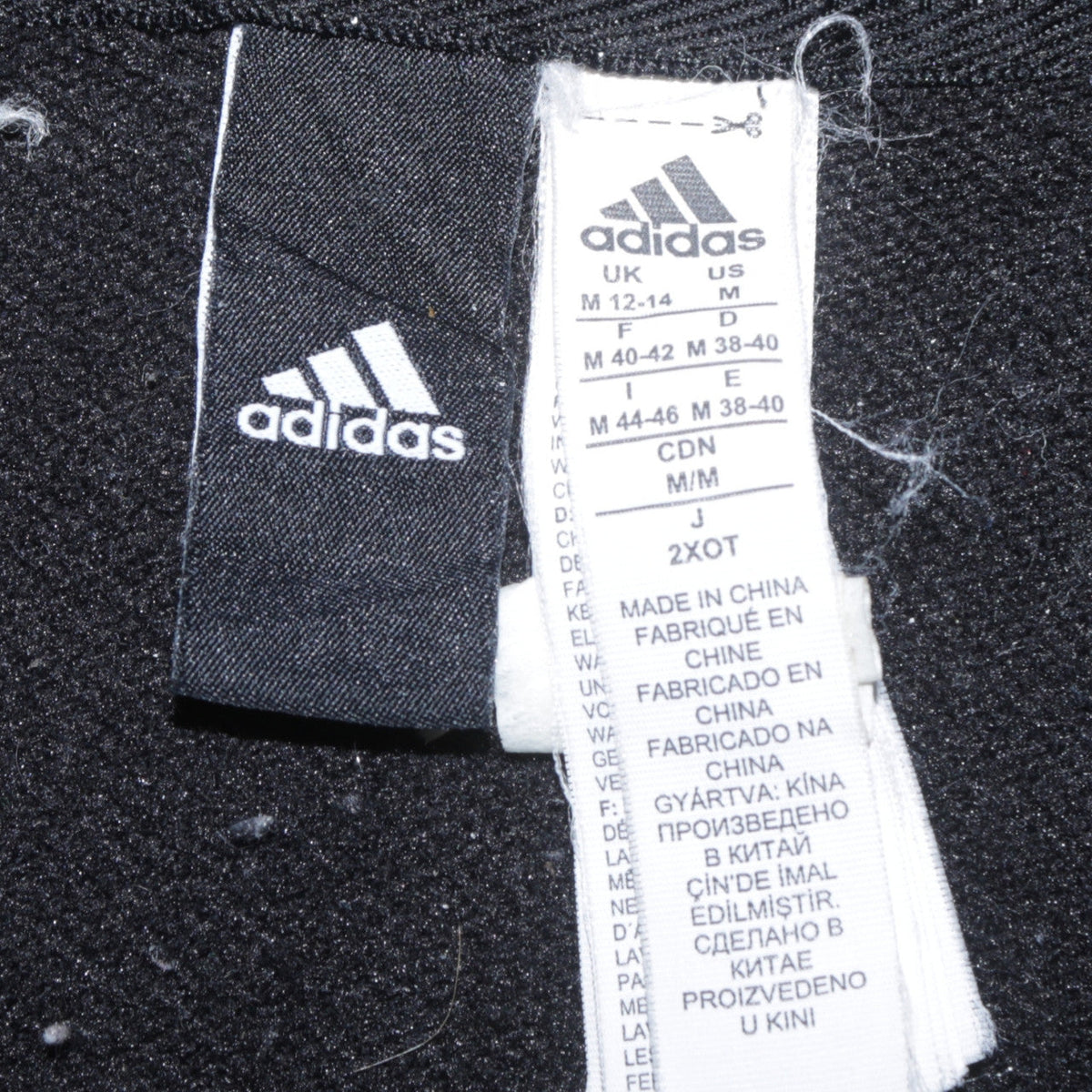 Close-up detail of Adidas women’s black full zip hoodie, size M, 12-14 logo sleeve