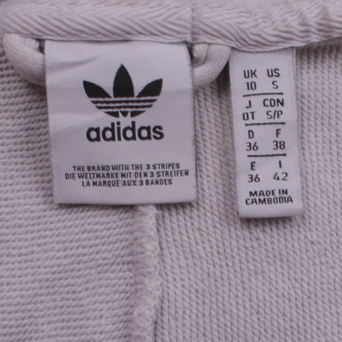 Close-up detail of Adidas women’s grey & white full zip hoodie, size UK 10, uk