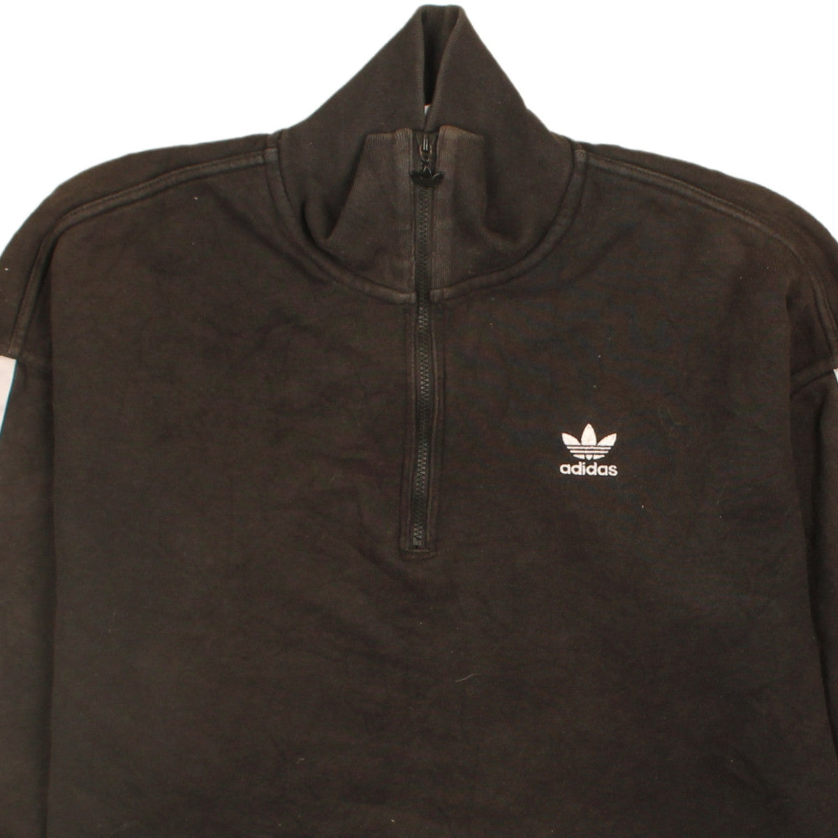 Brand and care label for Adidas women’s black 1/2 zip sweatshirt, size UK 12, logo detail