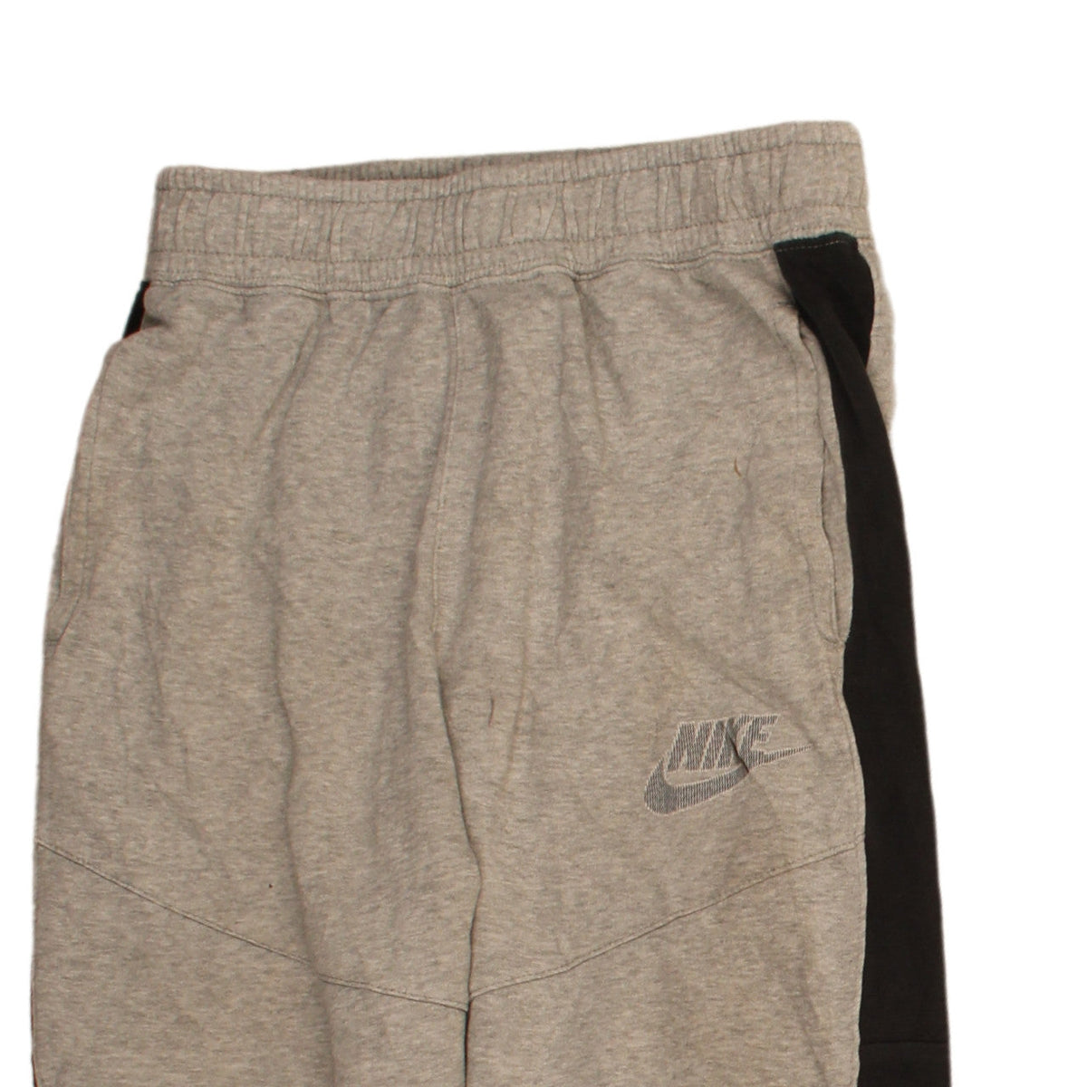 Brand and care label for Nike boys’ grey xl jogger sweatpants with side stripes