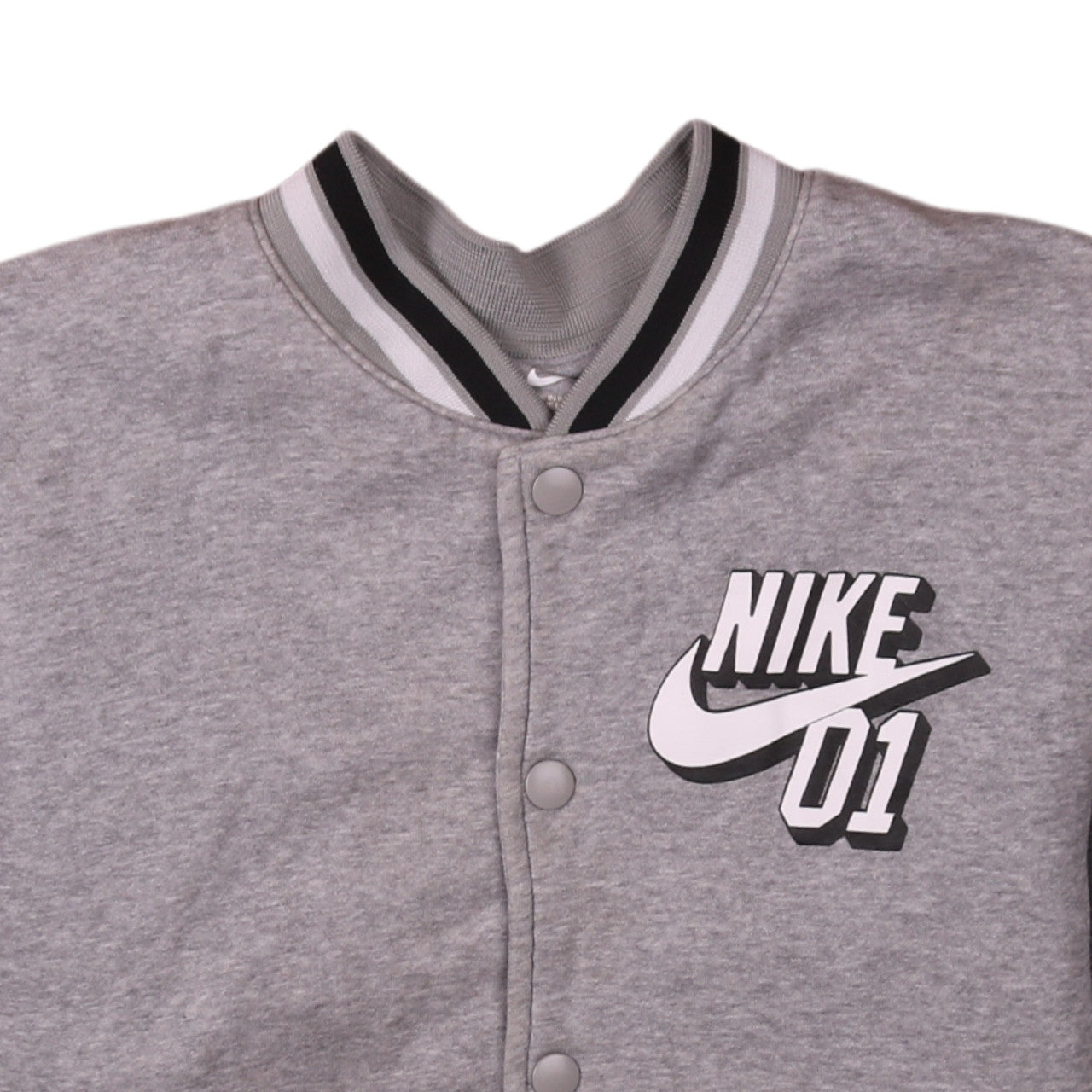 Brand and care label for Nike boys’ grey varsity jacket, size 12-13, years snap fastening lined