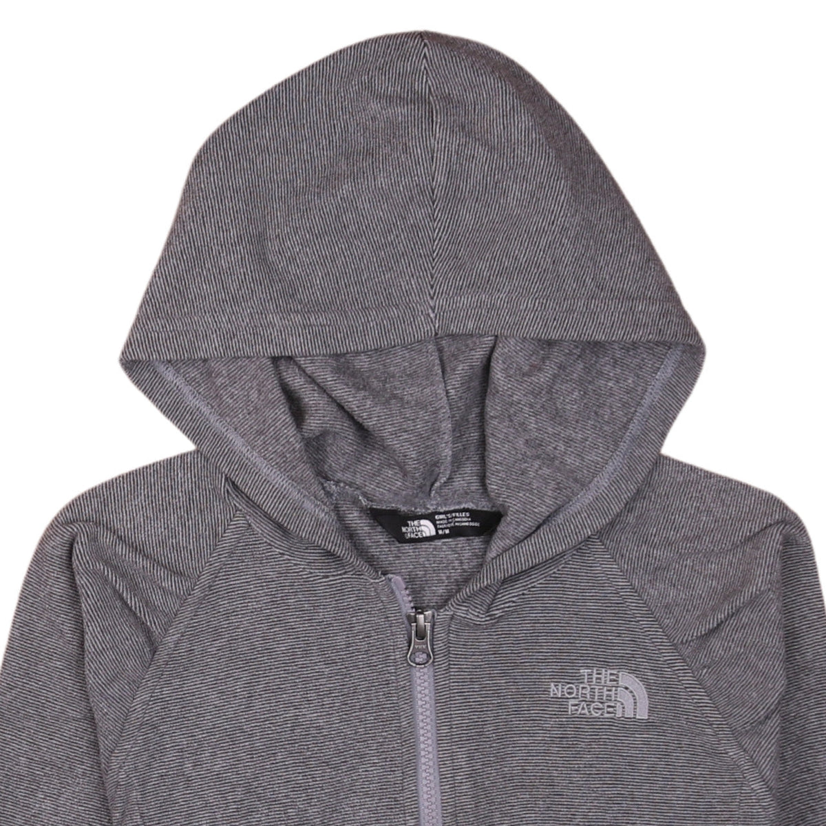 Brand and care label for The North Face girls’ grey hooded full zip fleece jacket, size M