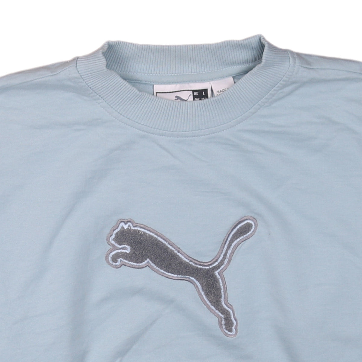 Brand and care label for Puma women’s blue pullover sweatshirt, size UK 12, crew neck logo