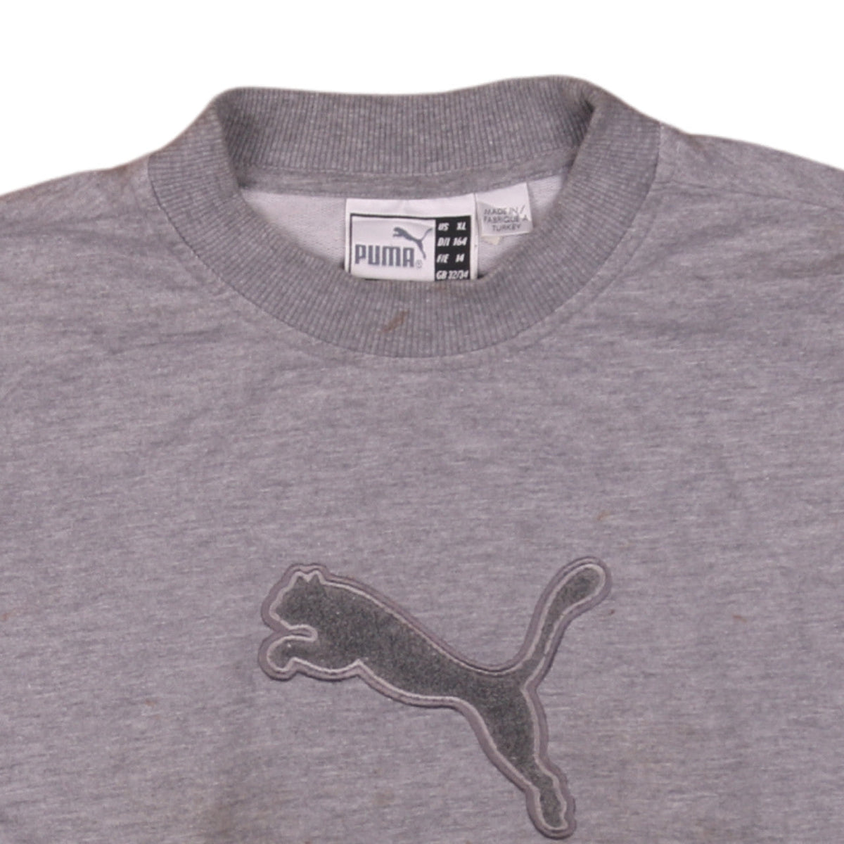 Brand and care label for Puma boys’ grey crew neck pullover sweatshirt, size 164, logo embroidered top