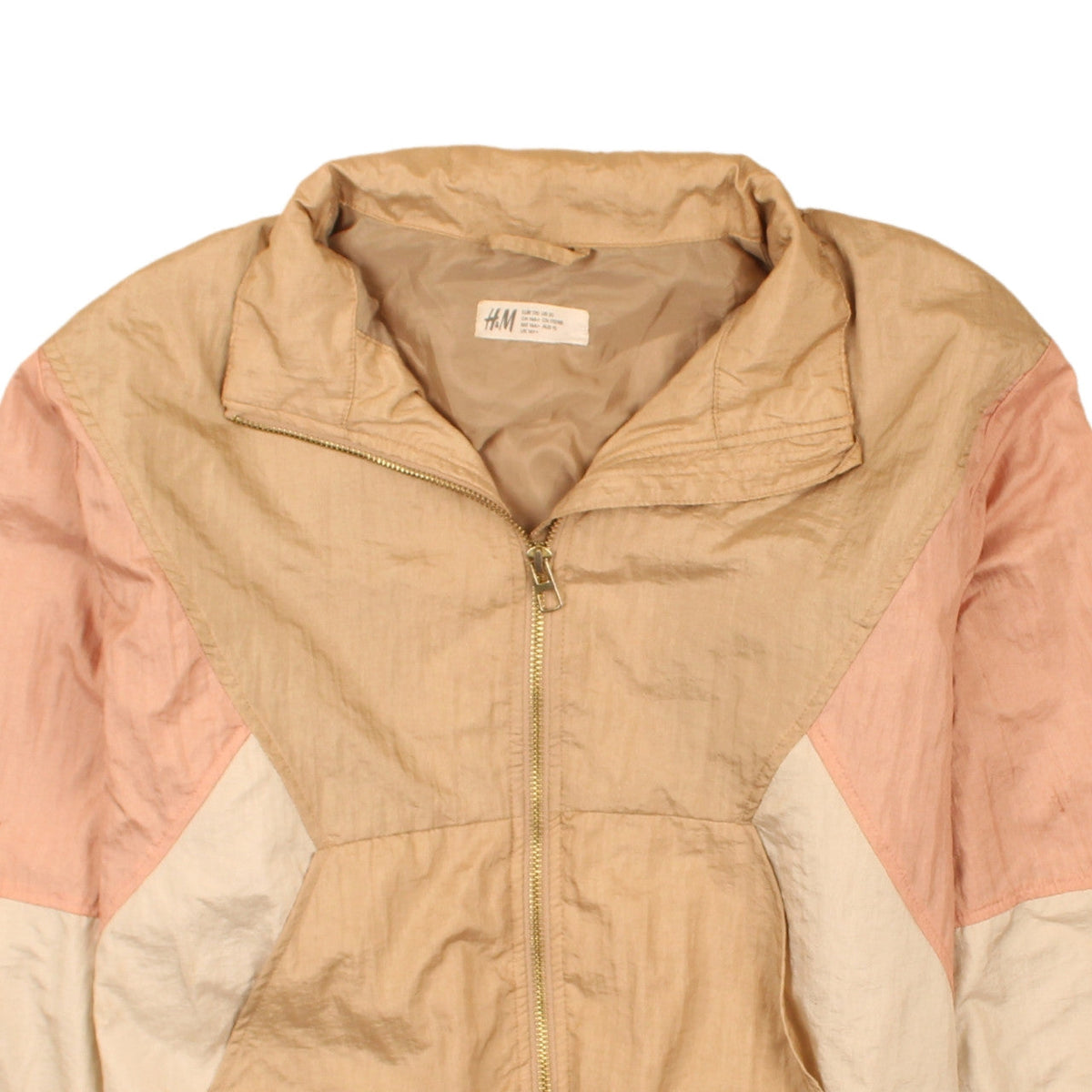 Brand and care label for H&M girls’ beige colourblock windbreaker jacket, size 14 plus