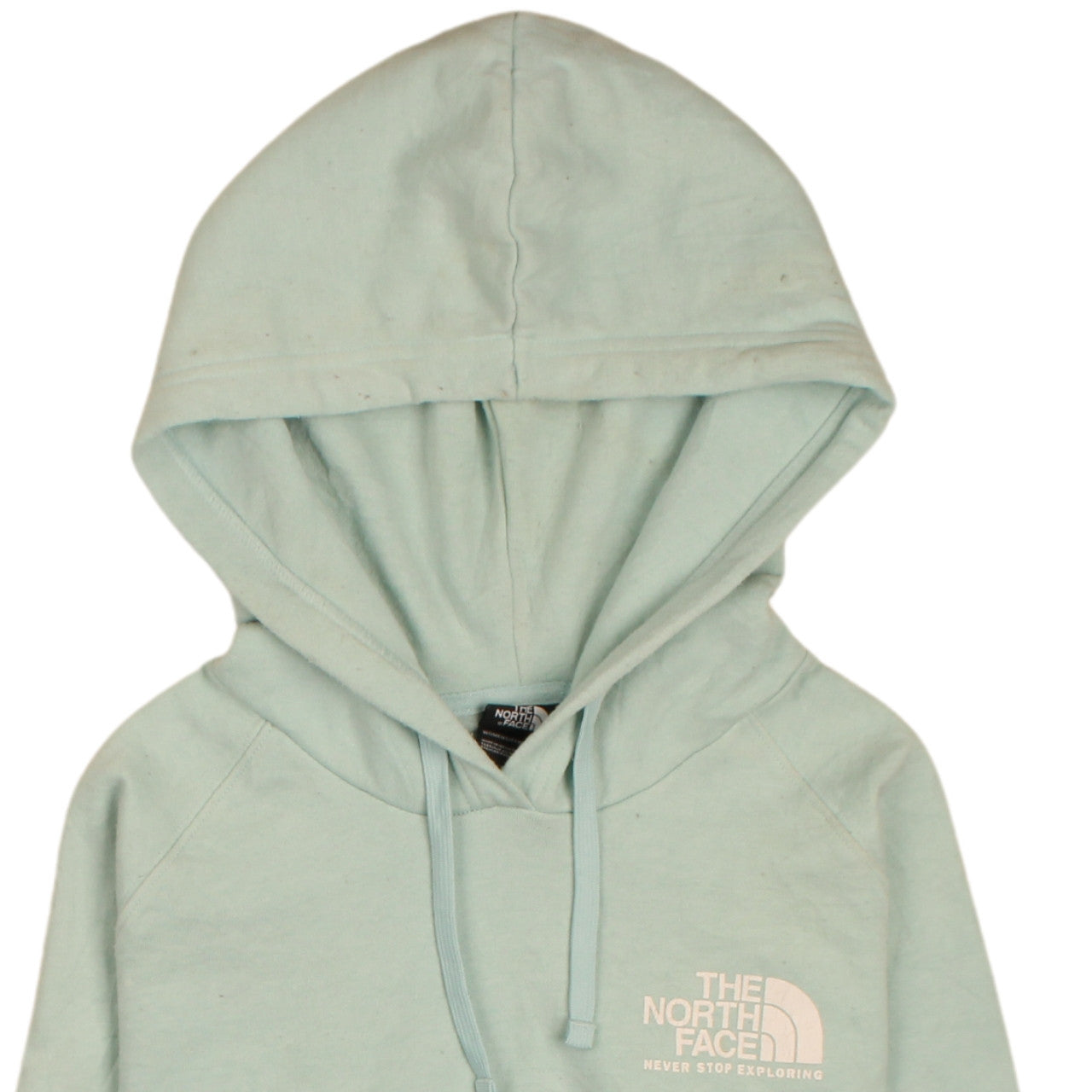 Brand and care label for The North Face women’s green pullover hoodie, size M, logo print